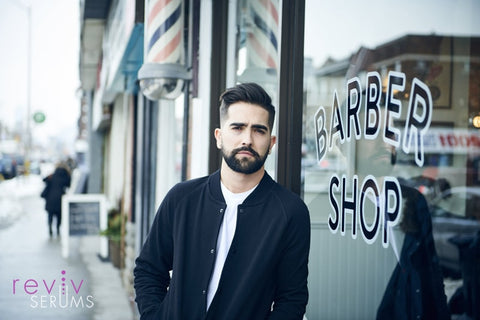 Man in front of barbershop
