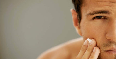Man applying skincare serum